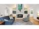 Cozy living room features a brick fireplace, hardwood floors, and large windows at 2004 Flagstone Pl, Raleigh, NC 27612
