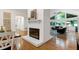 Open-concept layout with a central brick fireplace and abundant natural light from large windows at 2004 Flagstone Pl, Raleigh, NC 27612