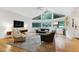 Bright living room featuring vaulted ceilings, large windows, hardwood floors, and stylish furnishings at 2004 Flagstone Pl, Raleigh, NC 27612