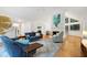 Spacious living room with hardwood floors, white brick fireplace, and large windows offering ample natural light at 2004 Flagstone Pl, Raleigh, NC 27612