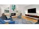 Bright living room featuring a fireplace, hardwood floors, recessed lighting, and modern furnishings at 2004 Flagstone Pl, Raleigh, NC 27612