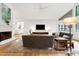 Bright living room with hardwood floors, white brick fireplace, vaulted ceilings, and modern furnishings at 2004 Flagstone Pl, Raleigh, NC 27612