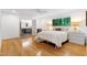 Bright main bedroom with ensuite bathroom featuring hardwood floors, natural light, and modern fixtures at 2004 Flagstone Pl, Raleigh, NC 27612