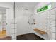 Modern walk-in shower with white subway tile and a window with wooded views at 2004 Flagstone Pl, Raleigh, NC 27612