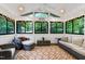 Cozy sunroom featuring ample seating, lots of natural light, and wooded views at 2004 Flagstone Pl, Raleigh, NC 27612