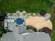 Aerial shot of the backyard featuring a patio, backyard seating, firepit, shed, and manicured lawn at 201 Margaret Mann Way, Pittsboro, NC 27312