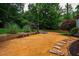 Beautiful private backyard with stone path and mature landscaping at 201 Margaret Mann Way, Pittsboro, NC 27312
