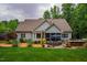 Backyard featuring a patio with an outdoor seating area, lawn, and mature trees at 201 Margaret Mann Way, Pittsboro, NC 27312