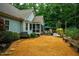 Inviting backyard featuring a patio, screened-in porch, lush landscaping, and a natural stone pathway at 201 Margaret Mann Way, Pittsboro, NC 27312
