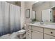 Bathroom with a single sink vanity, toilet, and bathtub with a shower curtain at 201 Margaret Mann Way, Pittsboro, NC 27312