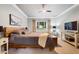 Bedroom features a window, ceiling fan, and carpet flooring and an entertainment center at 201 Margaret Mann Way, Pittsboro, NC 27312