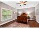 Bedroom with a wooden bed, hardwood floors, a window and an oriental rug at 201 Margaret Mann Way, Pittsboro, NC 27312