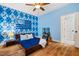 Blue bedroom with hardwood floors, a ceiling fan, and an ensuite bath at 201 Margaret Mann Way, Pittsboro, NC 27312
