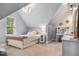 Angled-ceiling bedroom with a twin-size bed with gray carpeting at 201 Margaret Mann Way, Pittsboro, NC 27312