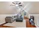 Comfortable bonus room featuring a large seating area and hardwood flooring at 201 Margaret Mann Way, Pittsboro, NC 27312