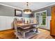 Well-lit dining room featuring hardwood floors, a rustic table, and ample natural light at 201 Margaret Mann Way, Pittsboro, NC 27312