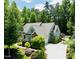 Charming home featuring lush landscaping, a spacious driveway, and a well-maintained yard at 201 Margaret Mann Way, Pittsboro, NC 27312