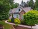 Charming home featuring stone accents, neat landscaping, and a welcoming front porch at 201 Margaret Mann Way, Pittsboro, NC 27312