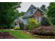 Charming two-story home with stone accents, covered porch, and mature landscaping at 201 Margaret Mann Way, Pittsboro, NC 27312