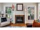 Cozy fireplace framed by windows, offering an inviting focal point in the living area at 201 Margaret Mann Way, Pittsboro, NC 27312