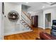 Open foyer with hardwood floors, staircase, and decorative shelving at 201 Margaret Mann Way, Pittsboro, NC 27312