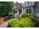 Charming two-story home with stone accents, covered porch, and beautifully landscaped front yard at 201 Margaret Mann Way, Pittsboro, NC 27312