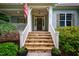 Inviting front entrance featuring stone steps, a covered porch, and a charming exterior at 201 Margaret Mann Way, Pittsboro, NC 27312