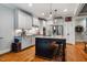 Modern kitchen featuring a large island, stainless steel appliances, granite countertops, and hardwood flooring at 201 Margaret Mann Way, Pittsboro, NC 27312