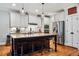 Bright kitchen with stainless steel appliances, granite countertops, and a kitchen island at 201 Margaret Mann Way, Pittsboro, NC 27312