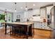 Well-appointed kitchen with a large island, stainless appliances, and abundant natural light at 201 Margaret Mann Way, Pittsboro, NC 27312