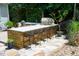 Custom outdoor kitchen with a pizza oven, built in grill, and bar seating at 201 Margaret Mann Way, Pittsboro, NC 27312