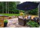Stone patio featuring an outdoor seating area and beautiful green trees at 201 Margaret Mann Way, Pittsboro, NC 27312