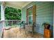 Cozy outdoor seating area on a porch with stone flooring and a view of the surrounding greenery at 201 Margaret Mann Way, Pittsboro, NC 27312