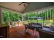 Relaxing screened porch with wood-burning pizza oven and view of the private backyard at 201 Margaret Mann Way, Pittsboro, NC 27312