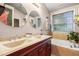 Bathroom features double vanity, natural light, and soaking tub at 202 Stonecreek Dr, Apex, NC 27539