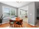 Cozy dining area with a round wooden table and a view of the back yard at 202 Stonecreek Dr, Apex, NC 27539