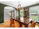 Elegant dining room with a large wooden table, stylish chairs, and decorative wall art at 202 Stonecreek Dr, Apex, NC 27539