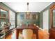 Elegant dining room with a large wooden table, stylish chairs, and decorative wall art at 202 Stonecreek Dr, Apex, NC 27539