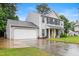 Charming two-story home with a well-manicured lawn, attached garage, and inviting yellow front door at 202 Stonecreek Dr, Apex, NC 27539