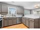 Modern kitchen with stainless steel appliances and gray cabinets. Hardwood flooring at 202 Stonecreek Dr, Apex, NC 27539
