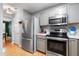 An updated kitchen with stainless steel appliances and a view into the dining area at 202 Stonecreek Dr, Apex, NC 27539