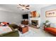 Cozy living room featuring a fireplace, comfortable seating, and a ceiling fan at 202 Stonecreek Dr, Apex, NC 27539