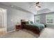 The main bedroom features a tray ceiling, ceiling fan and large windows at 202 Stonecreek Dr, Apex, NC 27539