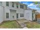 Backyard with a white-sided home, concrete patio, stone pavers, and partial fencing at 220 Misty Groves Cir, Morrisville, NC 27560