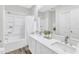 Clean bathroom featuring double vanity, large mirror, and shower-tub combination at 220 Misty Groves Cir, Morrisville, NC 27560