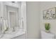 Bathroom featuring a white vanity, a framed mirror, and a toilet at 220 Misty Groves Cir, Morrisville, NC 27560