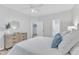 Bright bedroom with light walls, ceiling fan, and view of closet and bathroom at 220 Misty Groves Cir, Morrisville, NC 27560