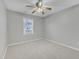 Bedroom with neutral tones, plush carpeting, and a window letting in natural light at 220 Misty Groves Cir, Morrisville, NC 27560