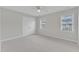 Carpeted bedroom featuring windows and a double-door closet, offering ample space at 220 Misty Groves Cir, Morrisville, NC 27560