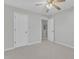 Bedroom featuring ceiling fan, plush carpeting, and adjoining room at 220 Misty Groves Cir, Morrisville, NC 27560
